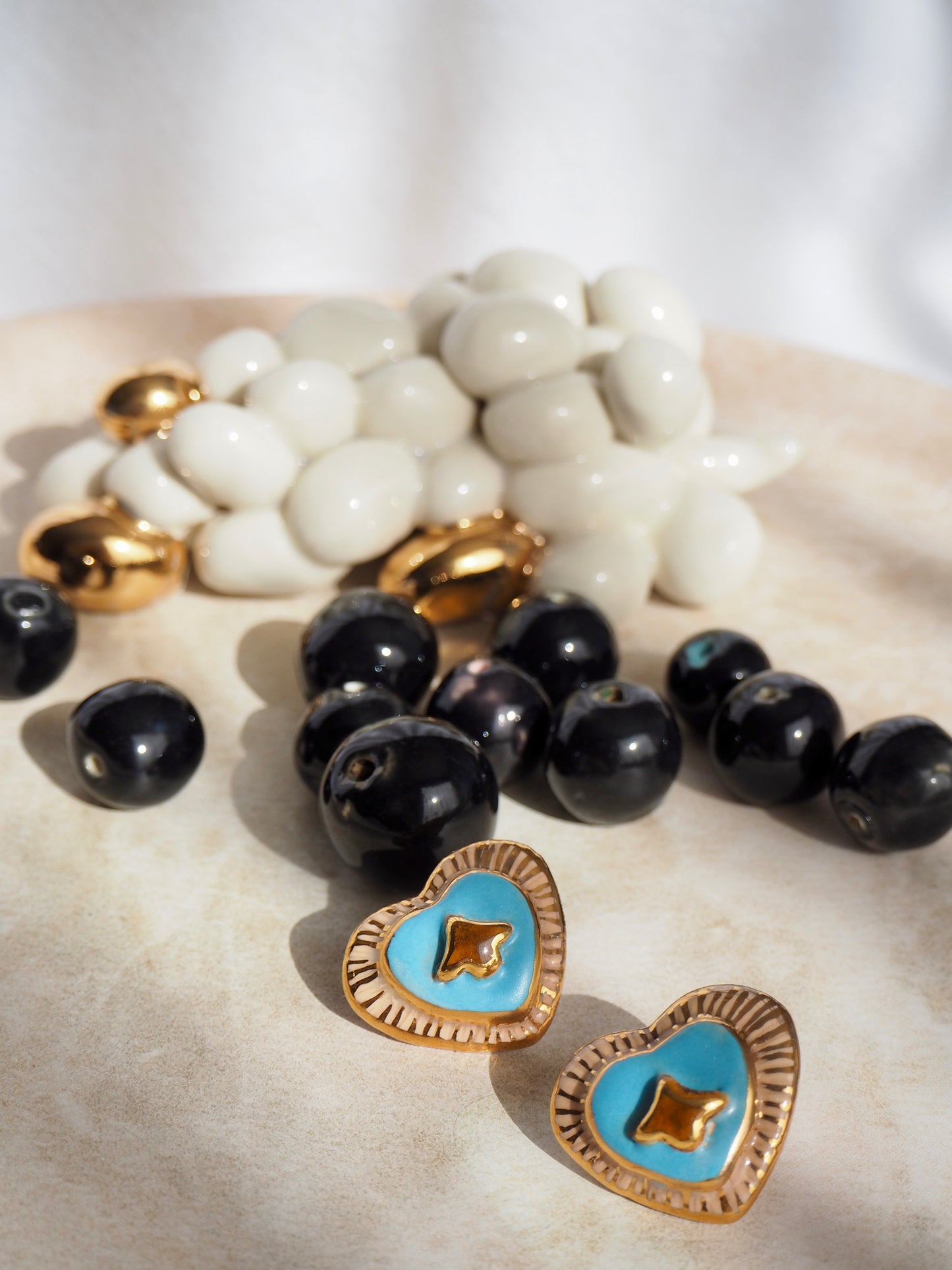 Porcelain Heart Earrings in “Parchment” coloured underglaze & Blue pearl glaze with 24k Gold lustre hand painted details