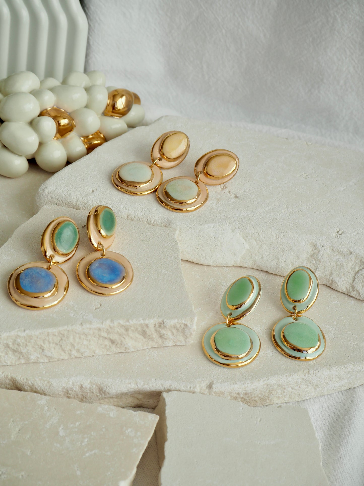 Femminilità Porcelain Earrings in Green and Blue coloured glossy glaze on Parchment underglaze with 24k Gold lustre textured rims