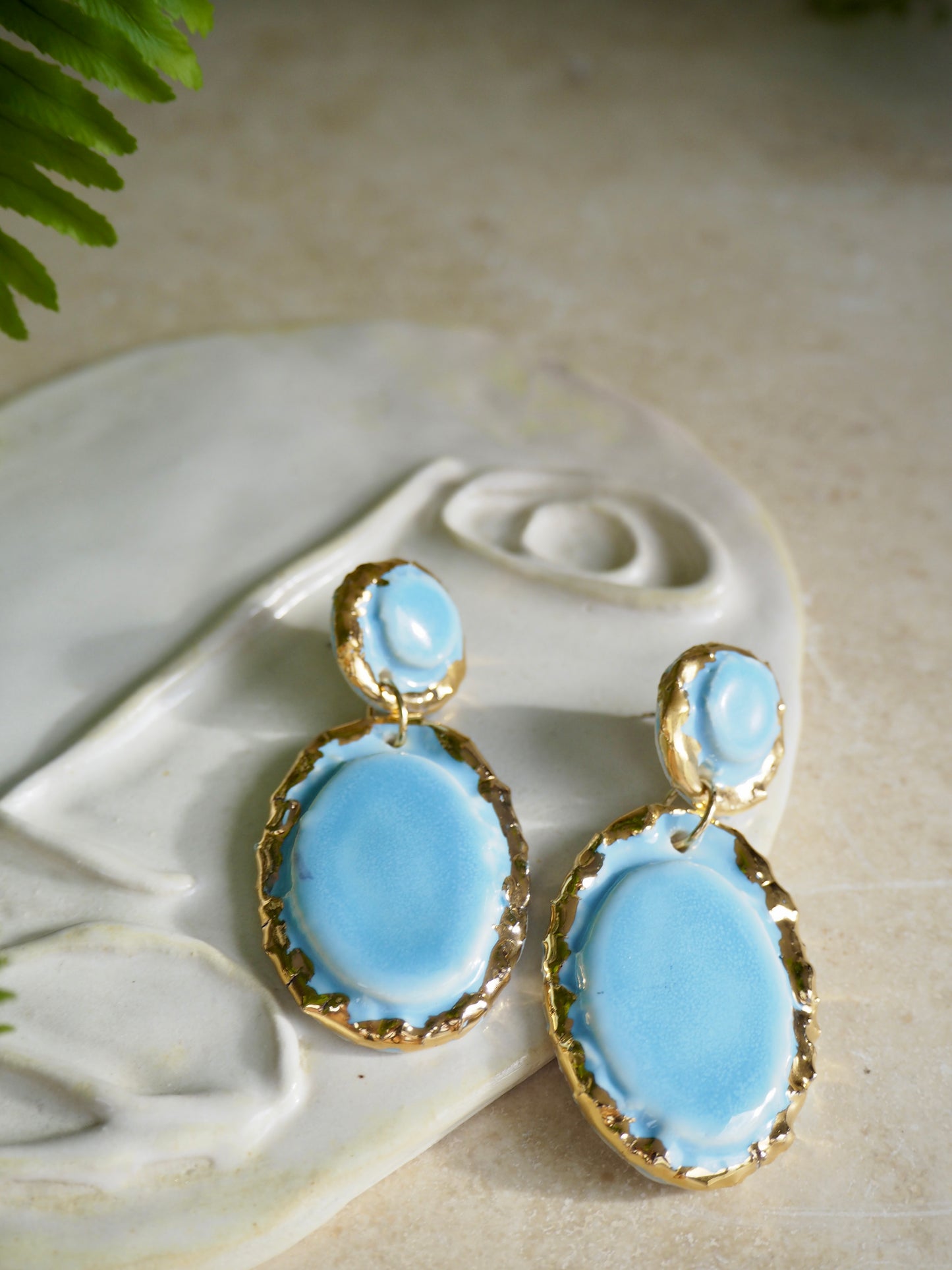 Femminilità Porcelain Earrings in “light Blue” coloured glossy glaze with 24k Gold lustre textured rims