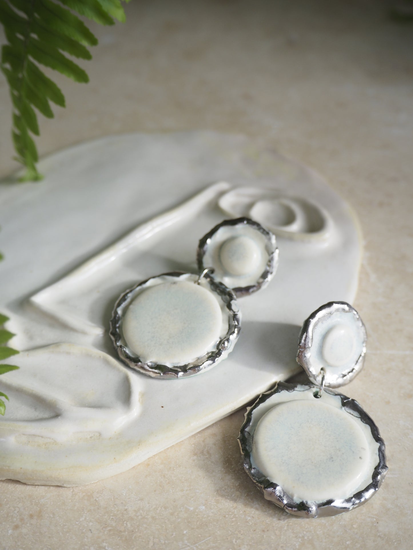 Femminilità Porcelain Earrings in “Snow” coloured glaze with Platinum lustre textured rims in a matte finish