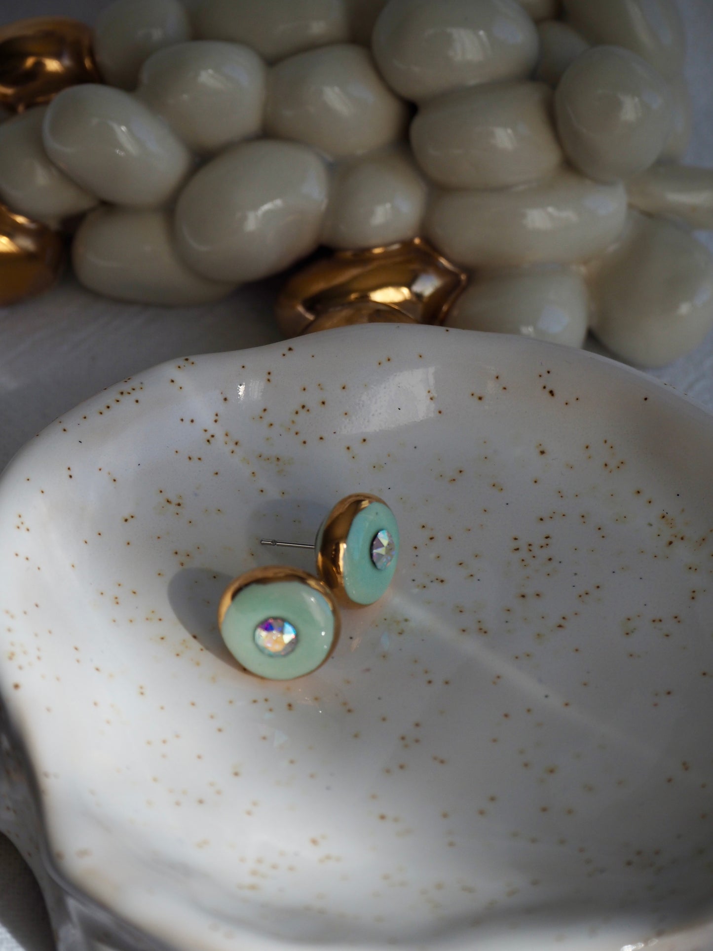 “Supernova” Light Green Small Handmade Porcelain Studs with 24k Gold lustre rims and “Aurora Borealis” Swarovskis Crystal.