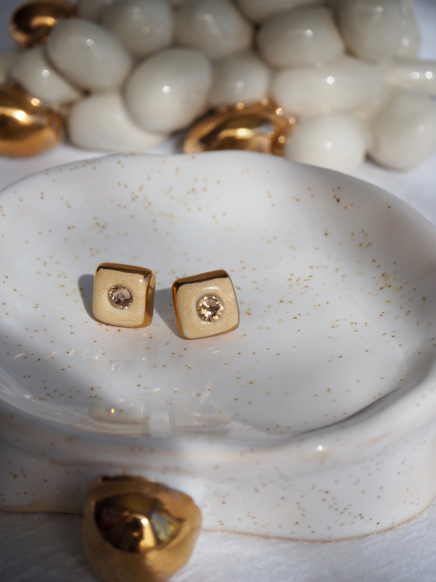“Supernova” Pale Orange Small Square Handmade Porcelain Studs with 24k Gold lustre rims and Swarovskis Cristals.