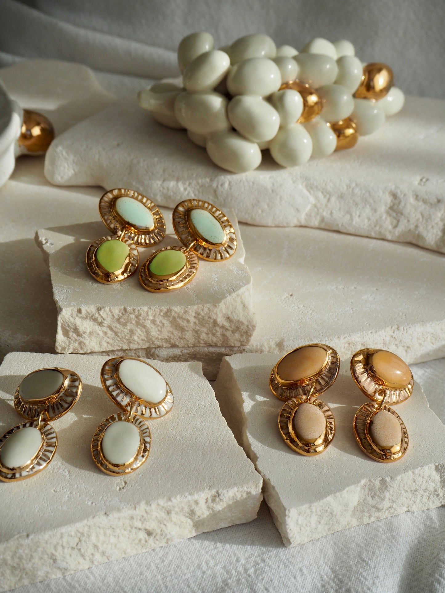 Hideaway Bay “Anima” Handmade Porcelain Earrings with Parchment underglaze and Green & Pale blue glazes with 24k gold lustre rays