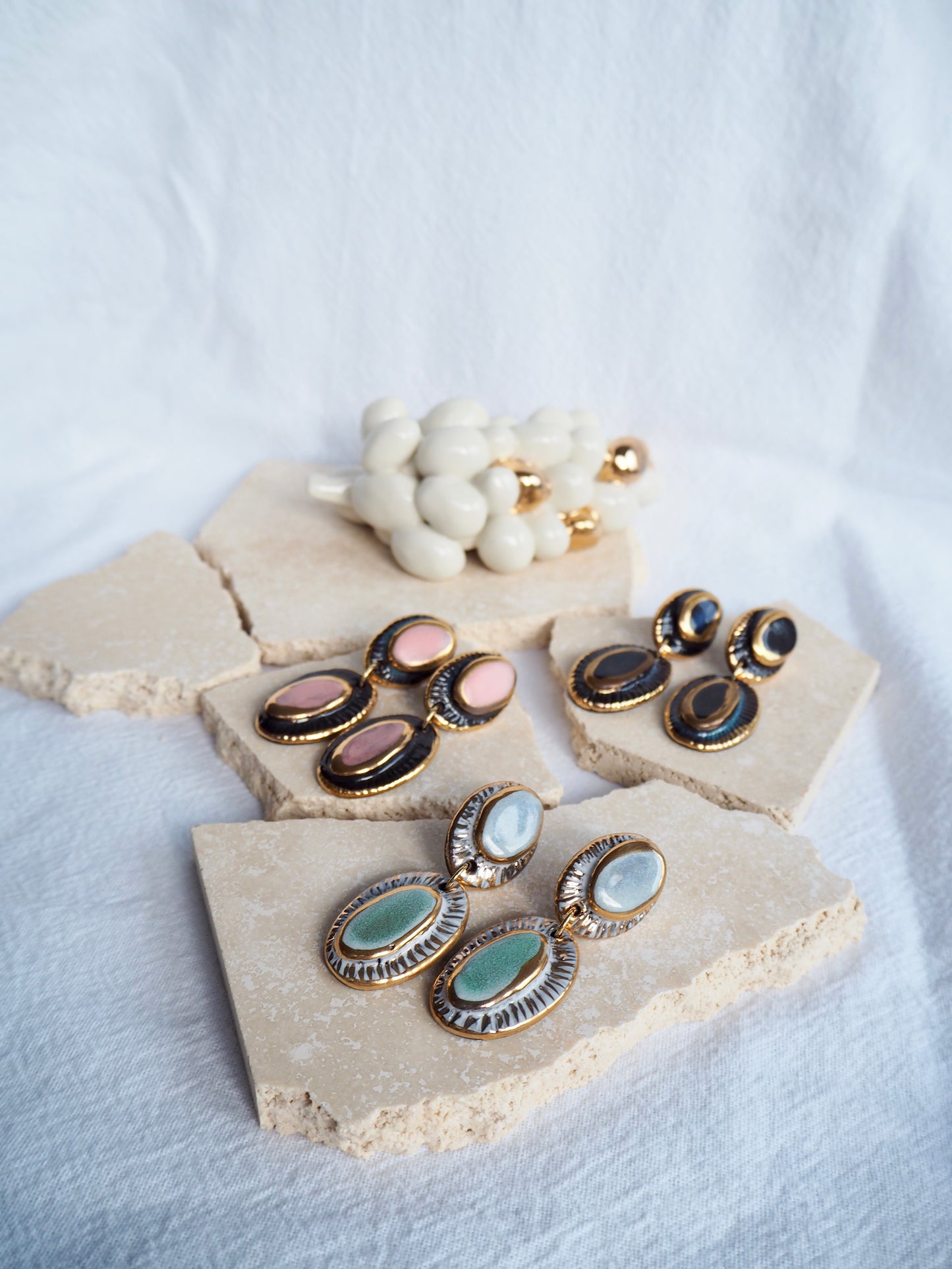 Pietra Collection handmade Black Clay Earrings coloured using light blue and green glaze with 24k gold lustre details