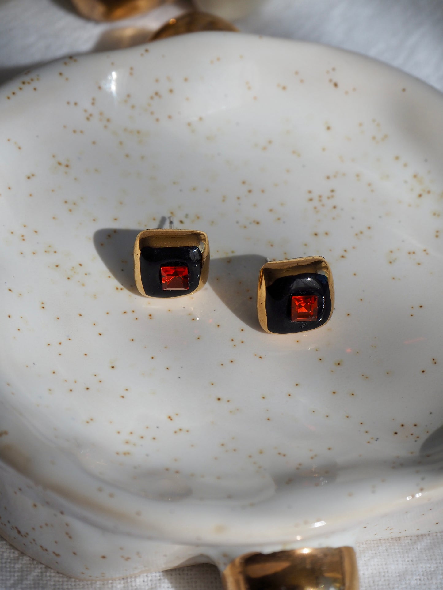 “Supernova” Black Small Square Handmade Porcelain Studs with 24k Gold lustre rims and an Swarovskis Crystal