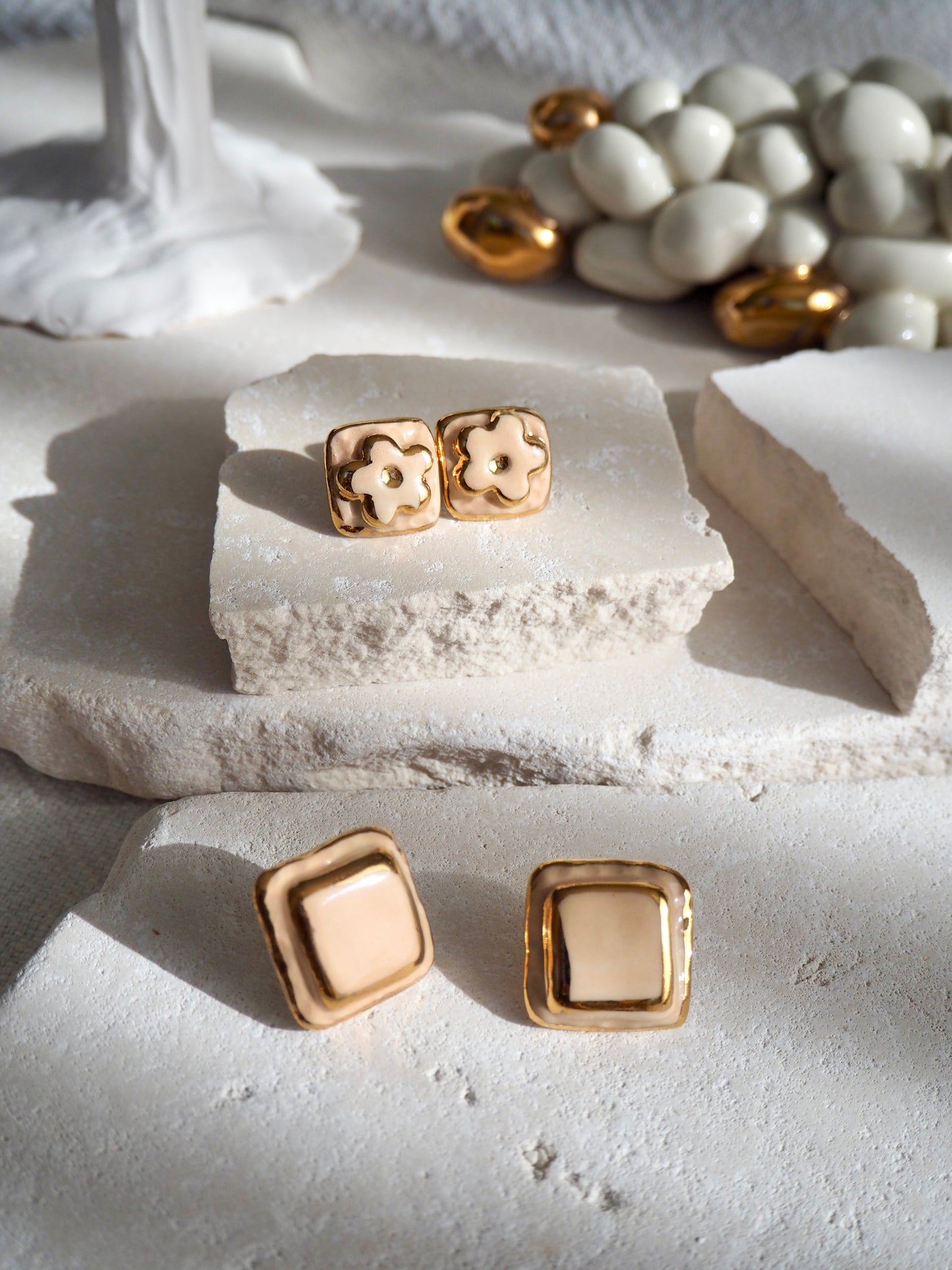 “il Quadrato’s Fiore Small Handmade Porcelain Studs coloured with “Light Beige” glossy glaze with 24k Gold lustre details