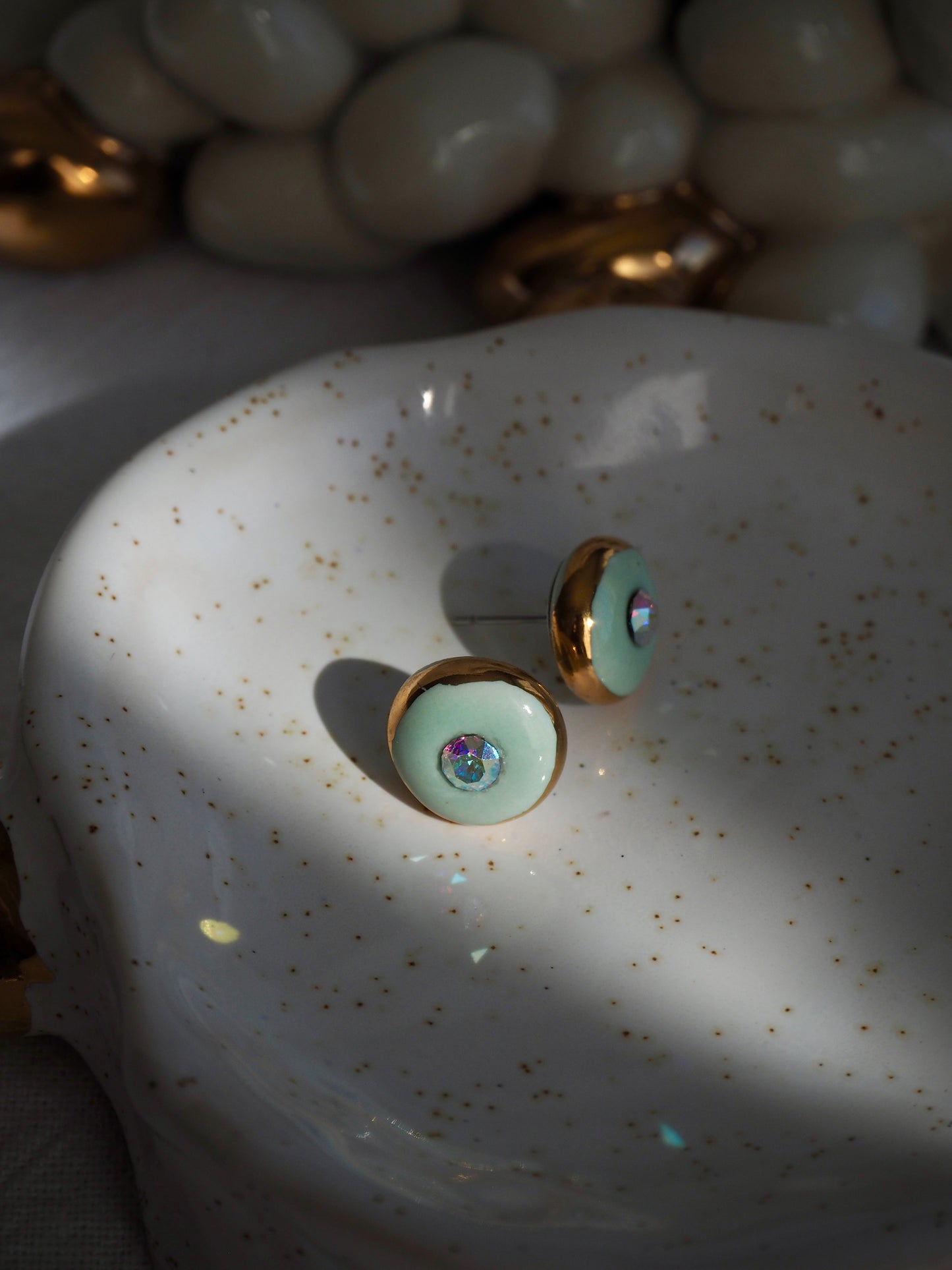 “Supernova” Light Green Small Handmade Porcelain Studs with 24k Gold lustre rims and “Aurora Borealis” Swarovskis Crystal.