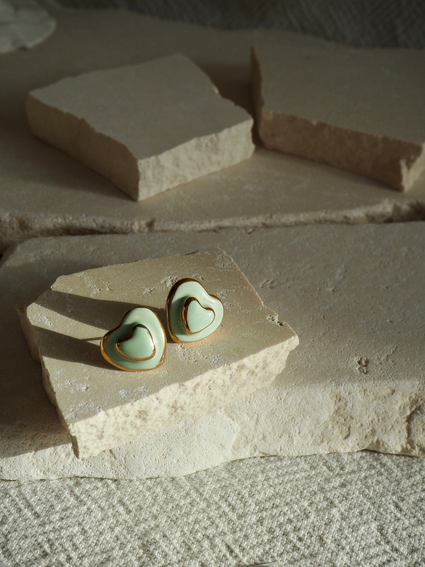 Small Handmade Porcelain Heart Stud coloured with “Light Sade” matt glaze with 24k Gold lustre details