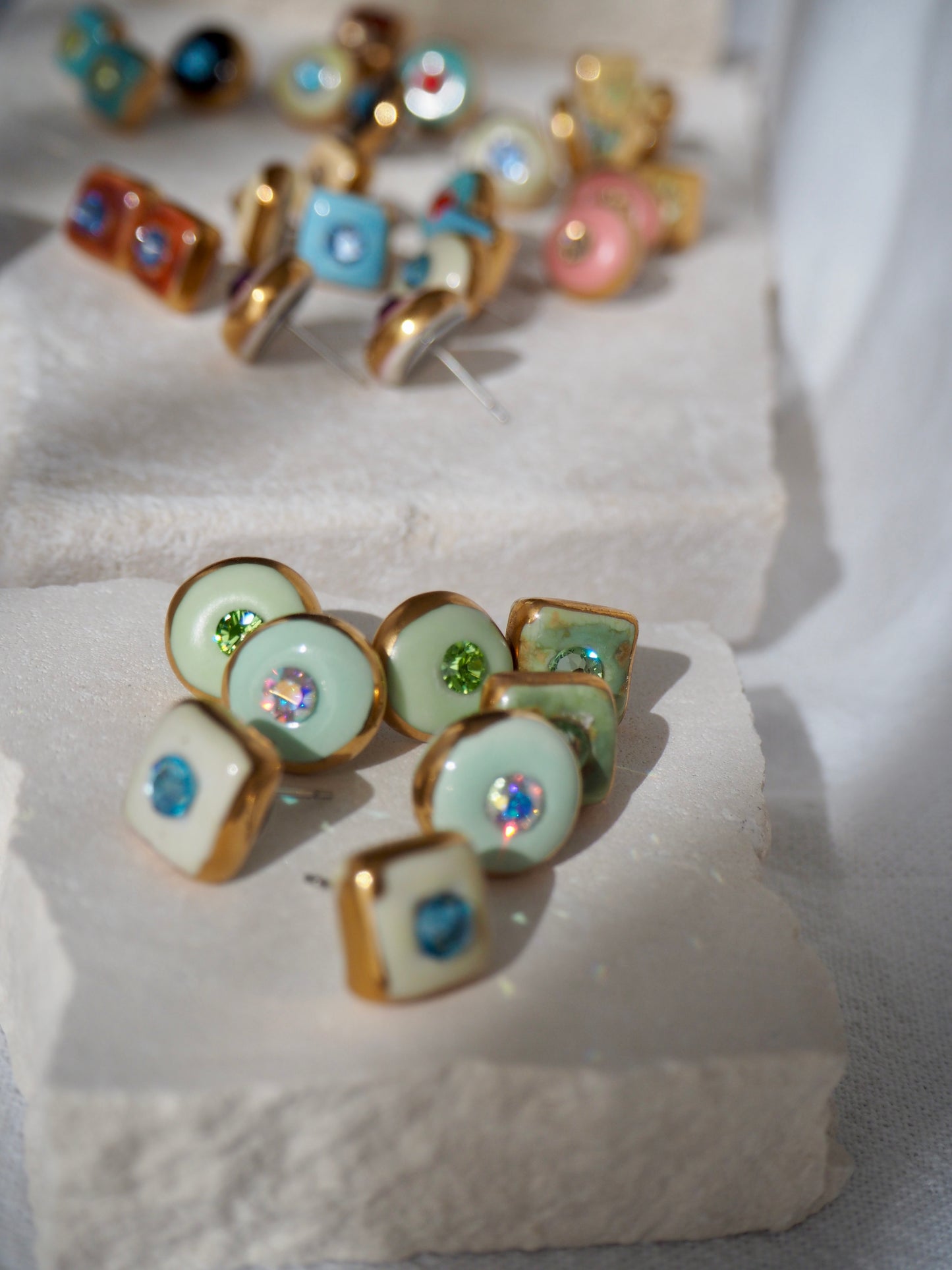 “Supernova” Light Green Small Handmade Porcelain Studs with 24k Gold lustre rims and “Aurora Borealis” Swarovskis Crystal.