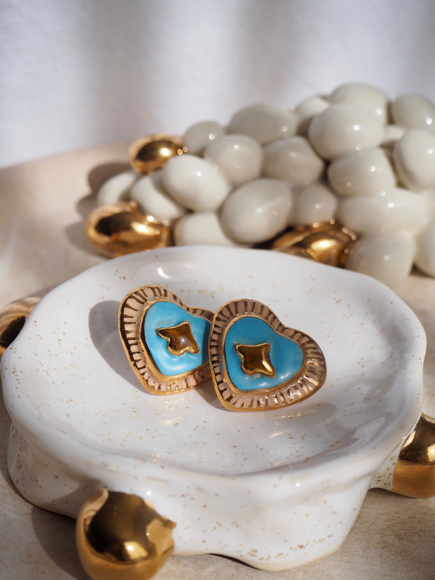 Porcelain Heart Earrings in “Parchment” coloured underglaze & Blue pearl glaze with 24k Gold lustre hand painted details