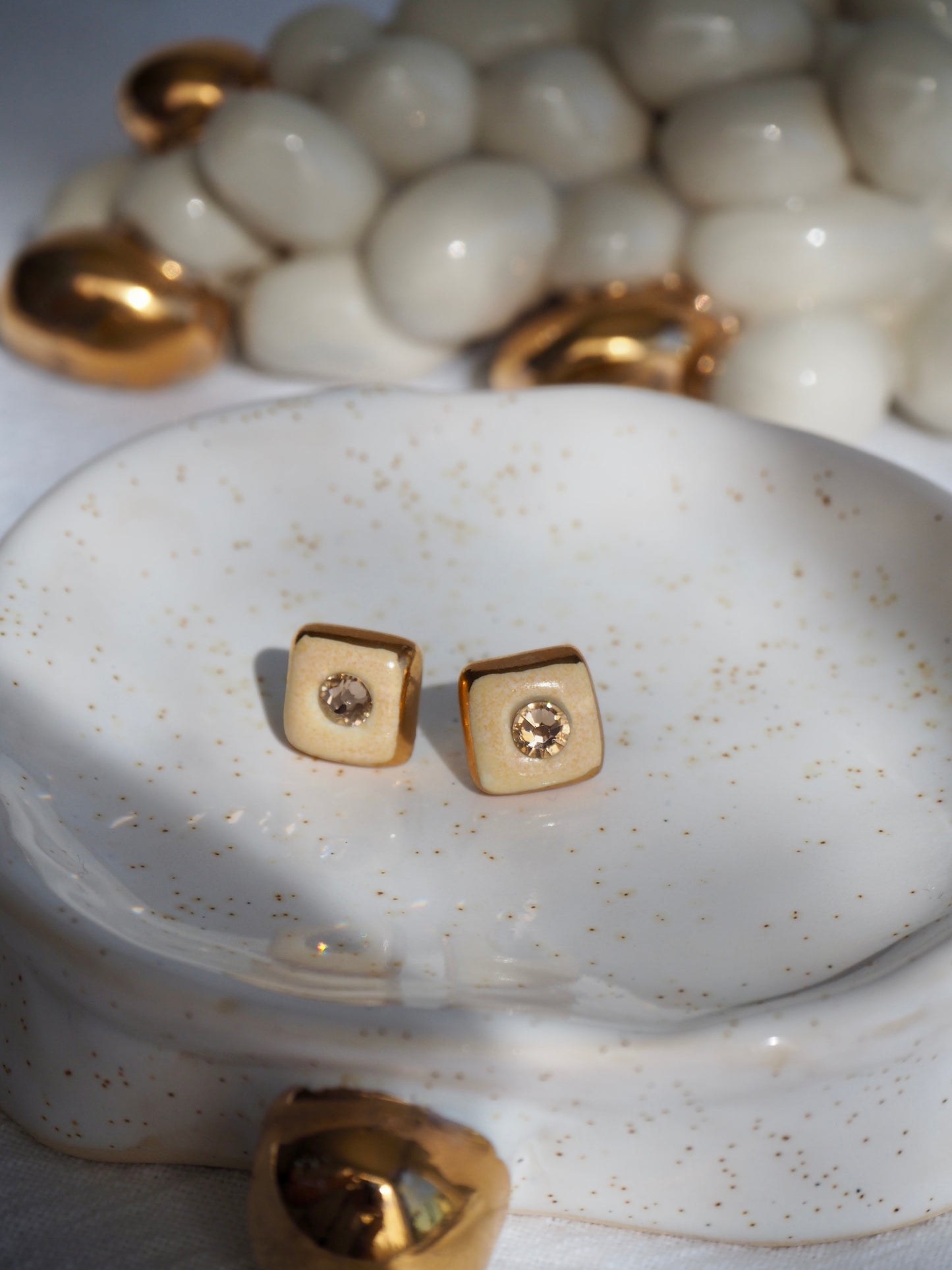 “Supernova” Pale Orange Small Square Handmade Porcelain Studs with 24k Gold lustre rims and Swarovskis Cristals.
