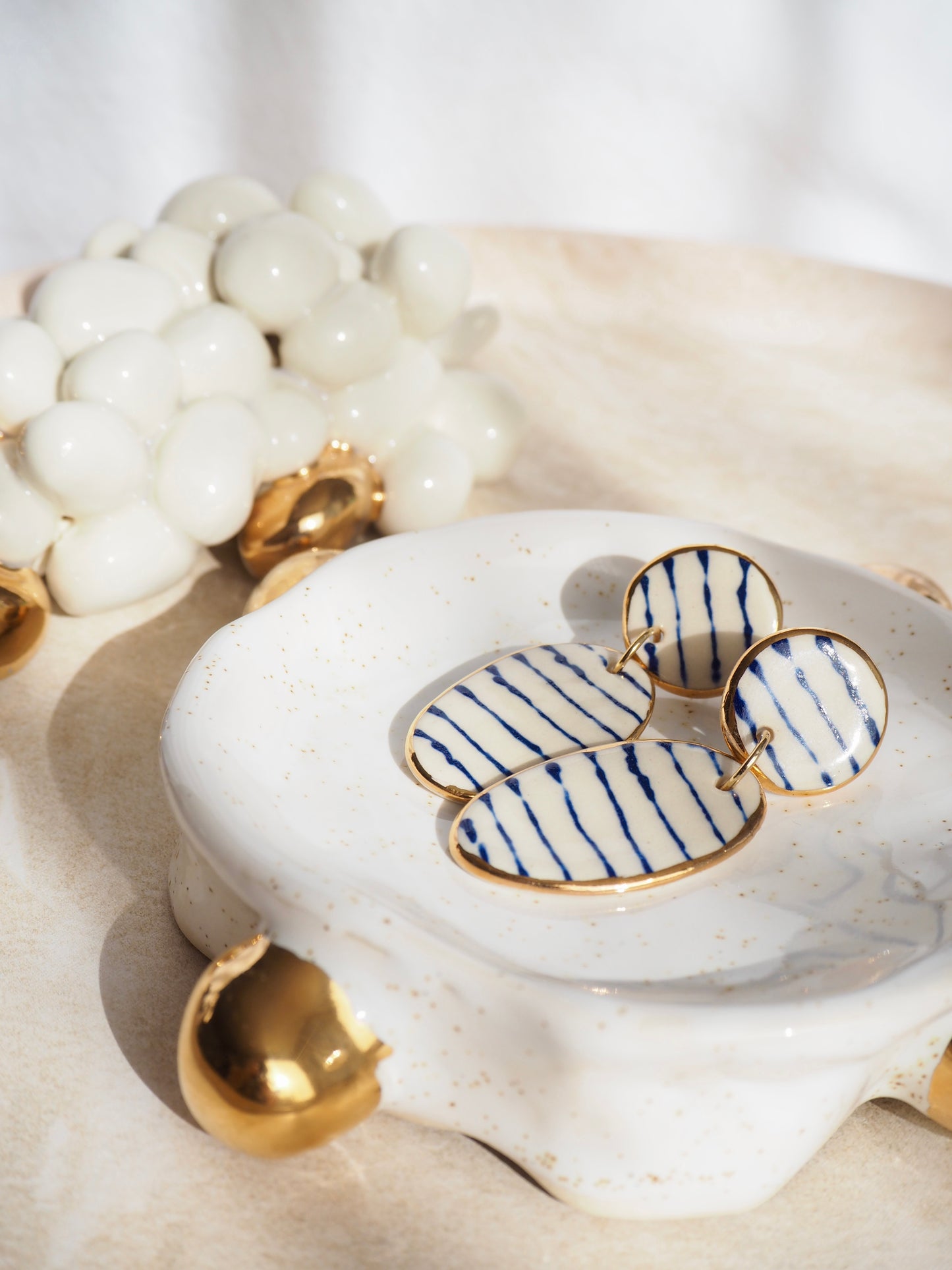Stripes on Porcelain Earrings in “Royal Blue” ceramic stain under clear glaze for glossy look 24k gold rims
