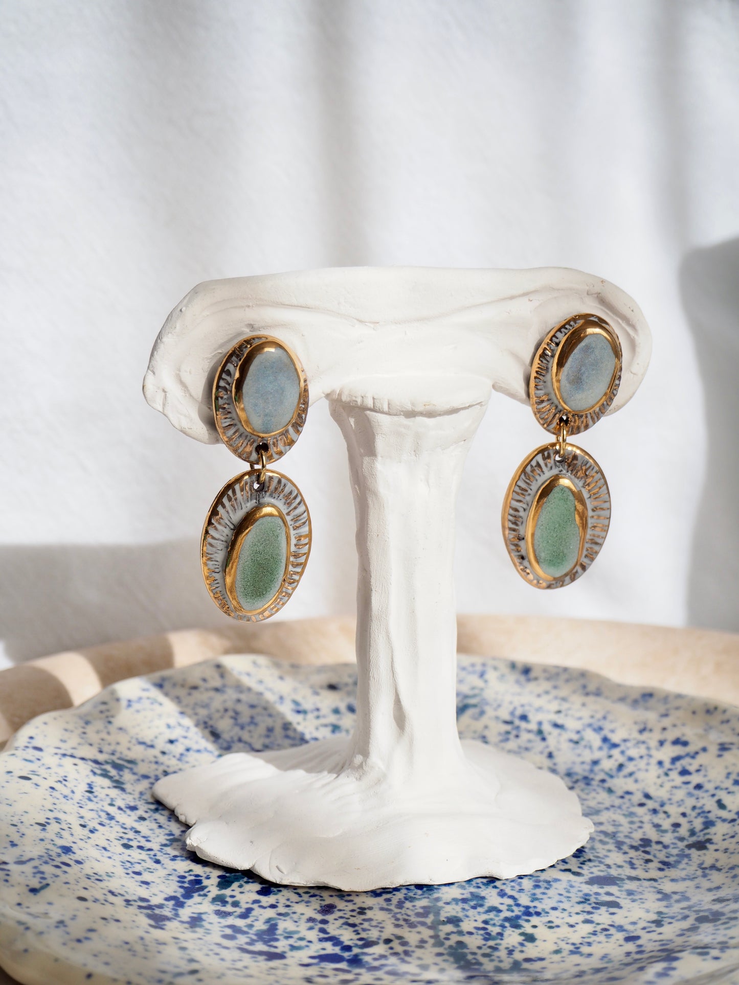 Pietra Collection handmade Black Clay Earrings coloured using light blue and green glaze with 24k gold lustre details