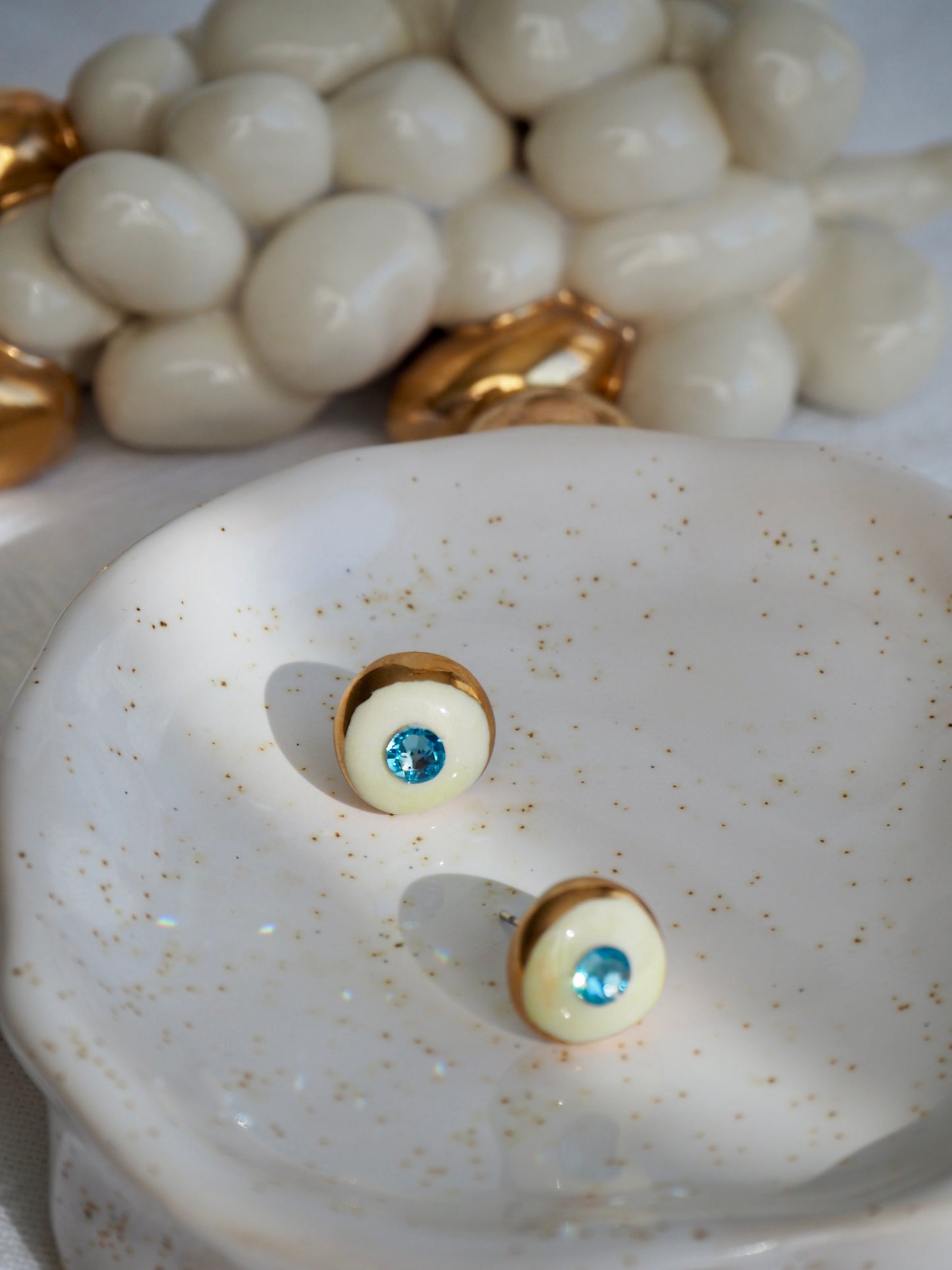 “Supernova” Off White Small Handmade Porcelain Studs with 24k Gold lustre rims and “light blue”Swarovskis Crystal