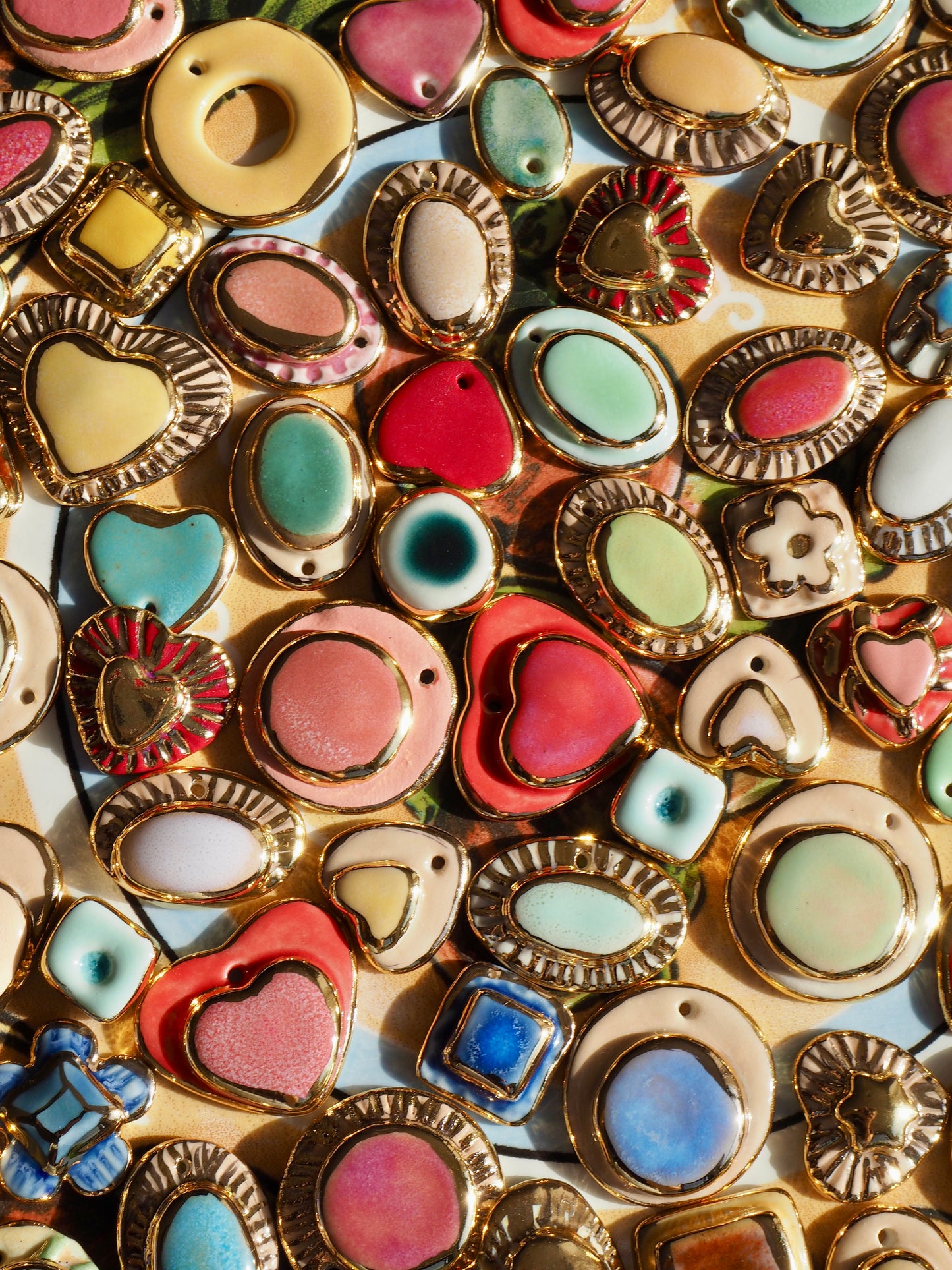 Small Handmade Porcelain Heart Stud Earrings coloured with Glossy Parchment coloured underglaze with 24k Gold lustre details and Gold center Star