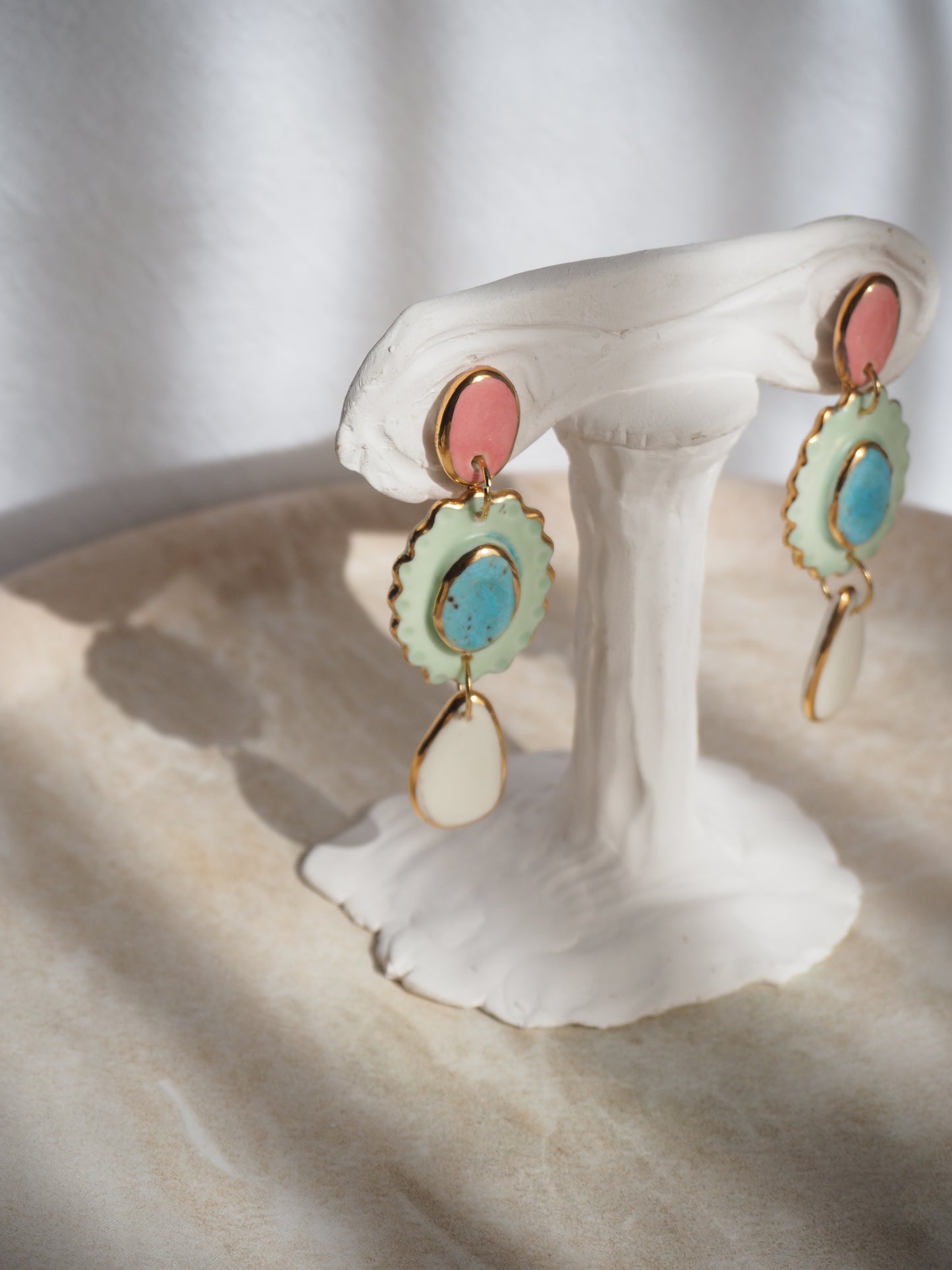 One of a kind Porcelain Earrings coloured with pink , aqua, light green and white glossy glazes with 24k lustre rims