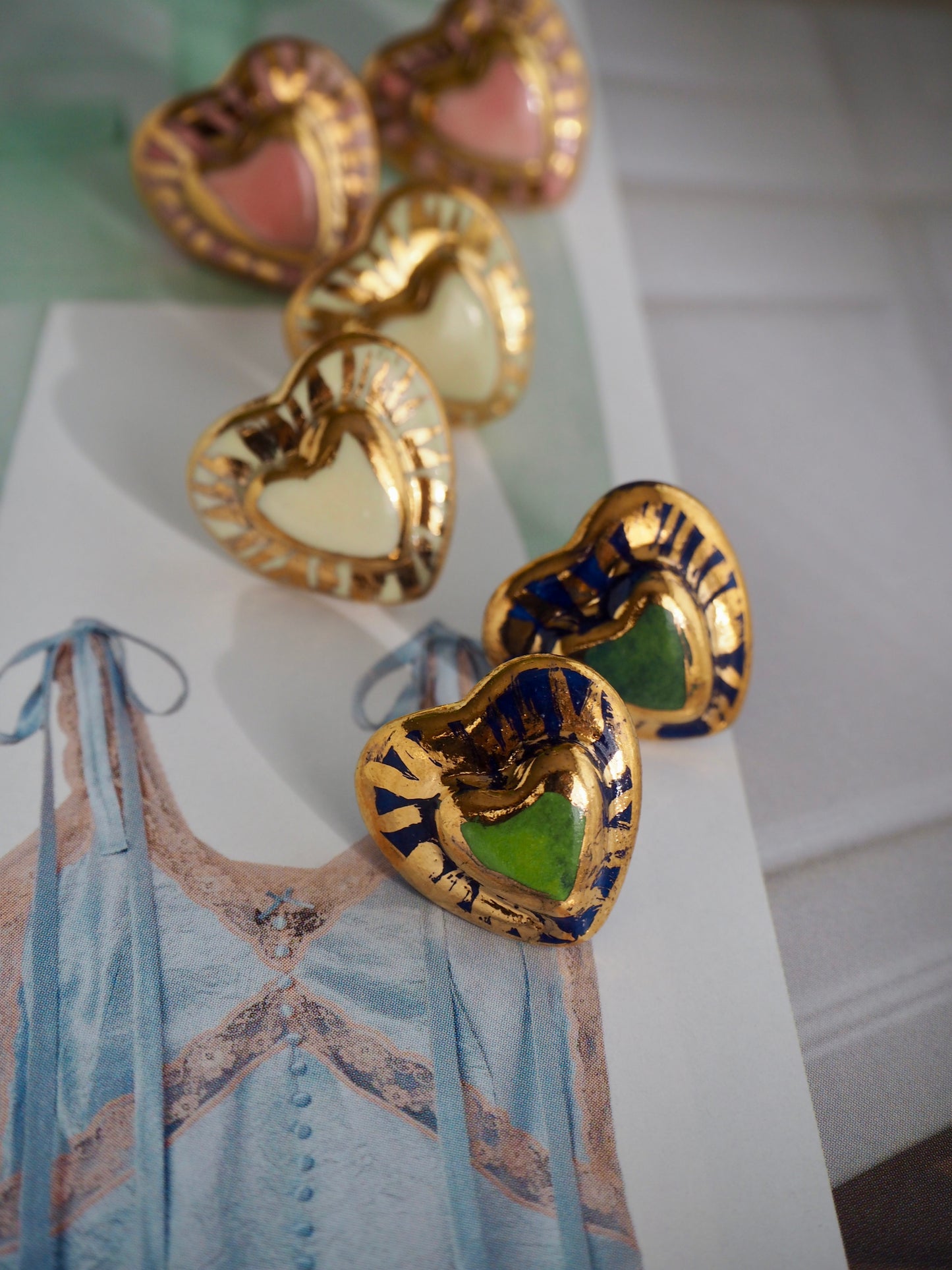 Small Handmade Porcelain Heart Stud coloured with “Dark Green and Blue” underglazes covered by glossy clear glaze with 24k Gold lustre rays