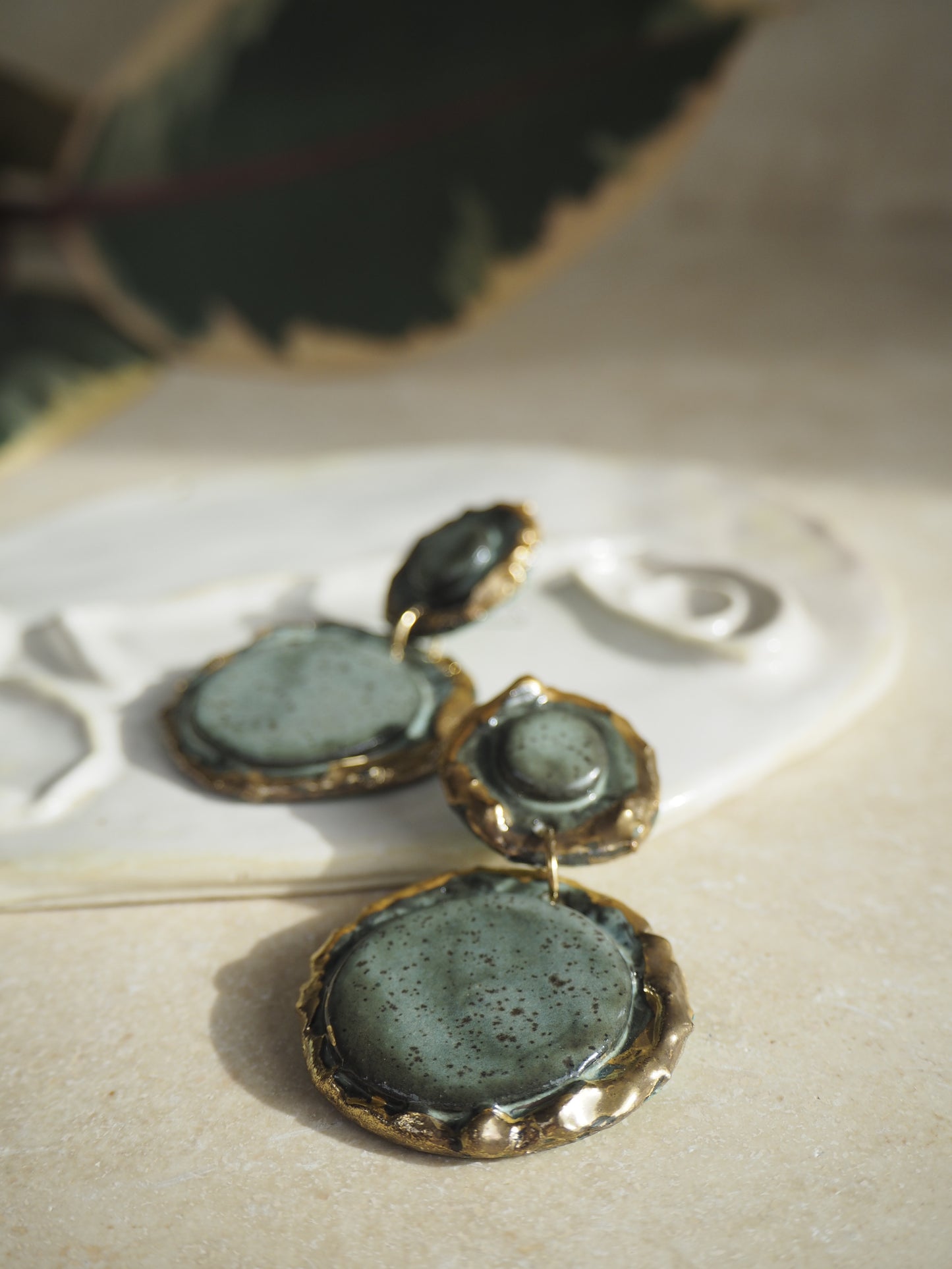 Femminilità Porcelain Earrings in a “green speckled ash” coloured glaze with 24k Gold lustre textured rims