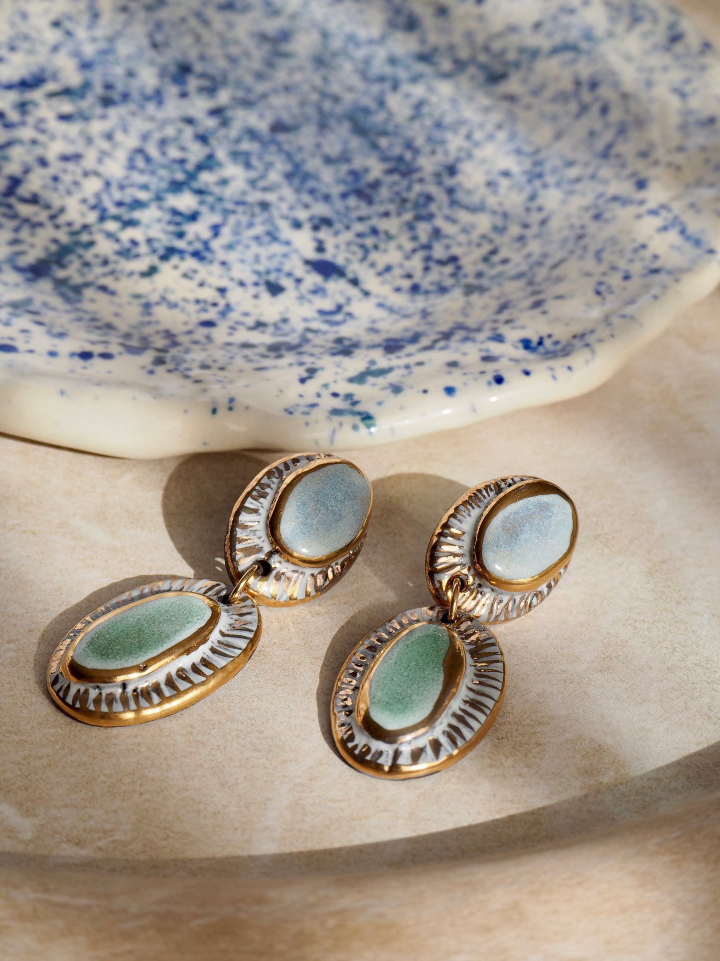Pietra Collection handmade Black Clay Earrings coloured using light blue and green glaze with 24k gold lustre details
