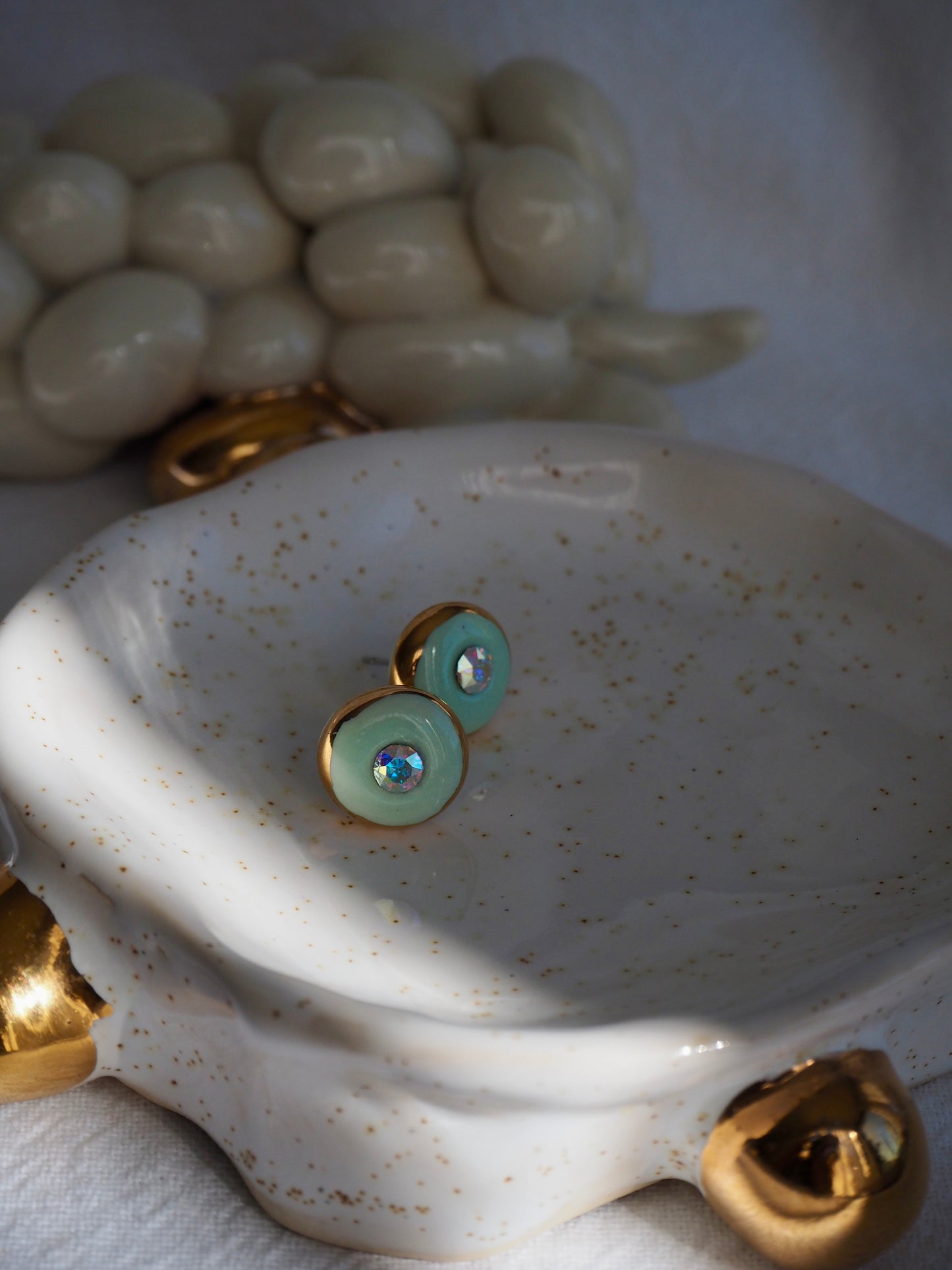 “Supernova” Light Green Small Handmade Porcelain Studs with 24k Gold lustre rims and “Aurora Borealis” Swarovskis Crystal.