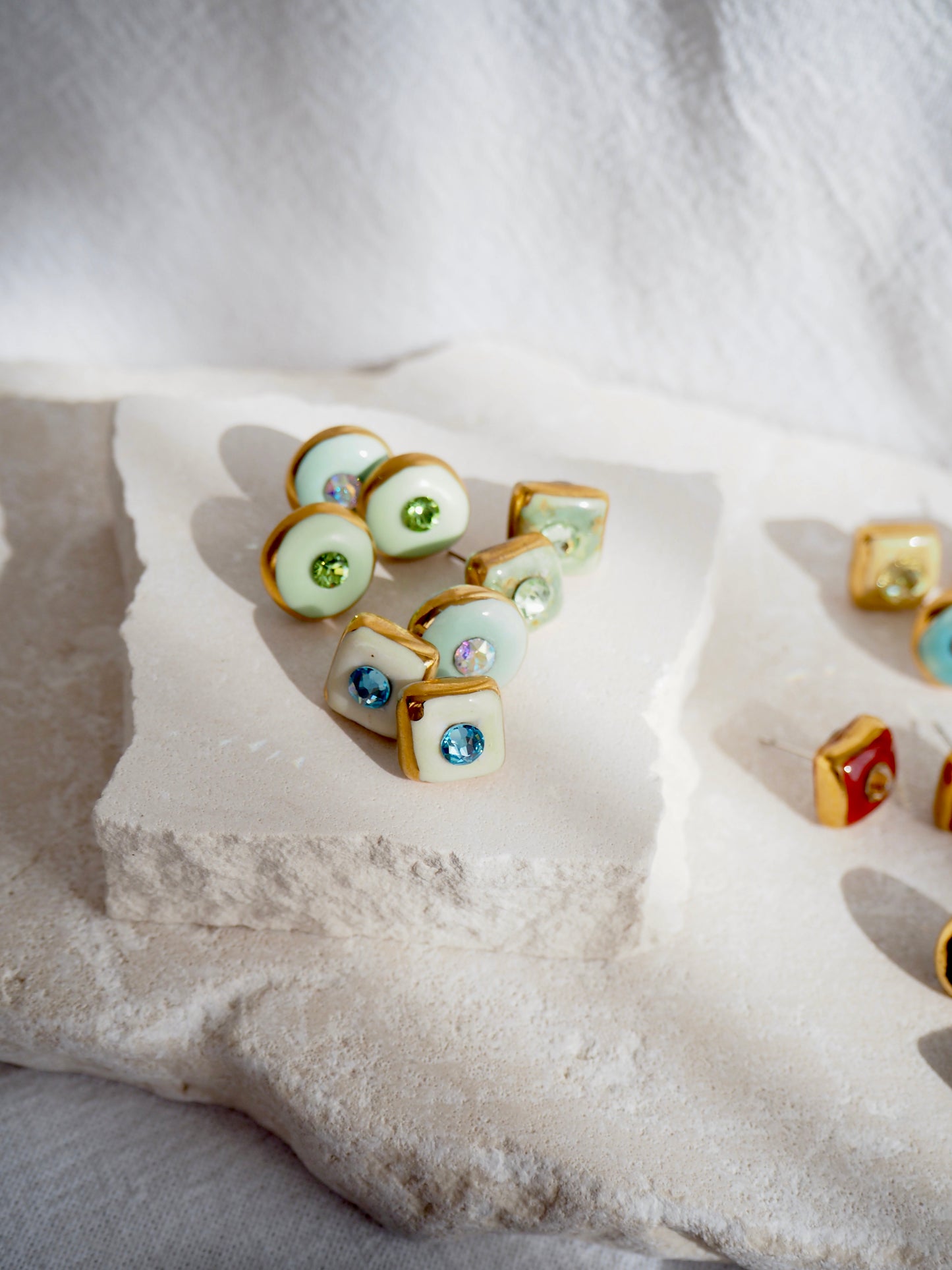 “Supernova” Light Green Small Handmade Porcelain Studs with 24k Gold lustre rims and “Aurora Borealis” Swarovskis Crystal.