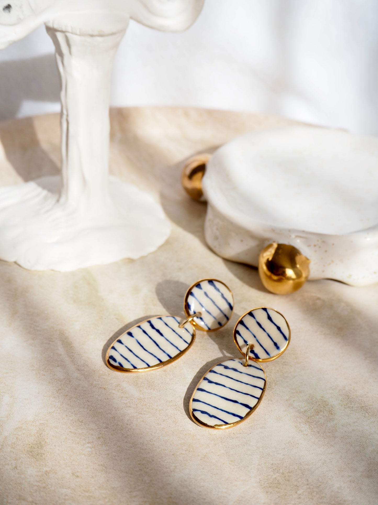 Stripes on Porcelain Earrings in “Royal Blue” ceramic stain under clear glaze for glossy look 24k gold rims