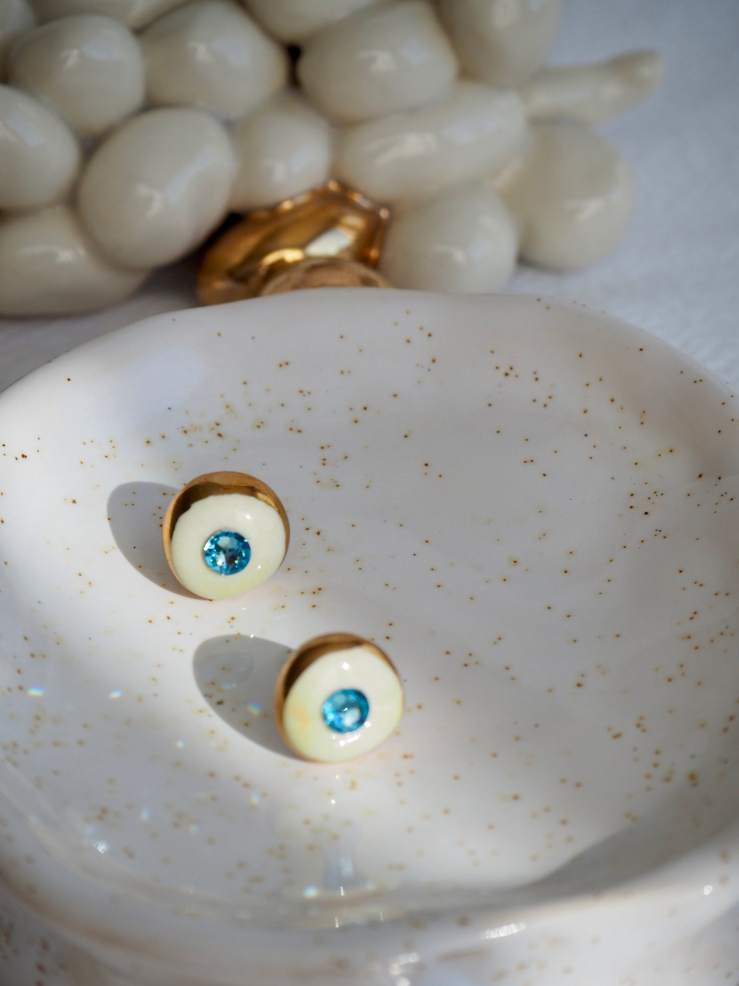 “Supernova” Off White Small Handmade Porcelain Studs with 24k Gold lustre rims and “light blue”Swarovskis Crystal