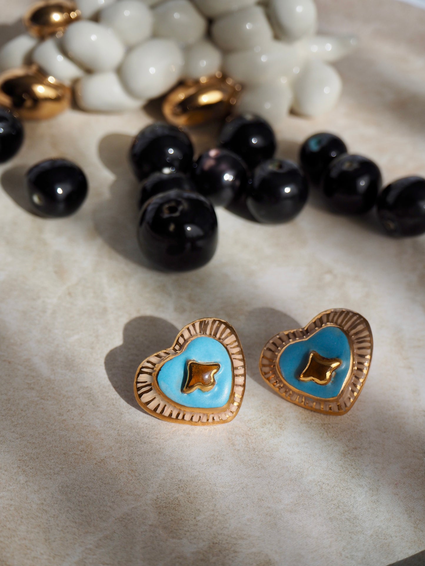 Porcelain Heart Earrings in “Parchment” coloured underglaze & Blue pearl glaze with 24k Gold lustre hand painted details
