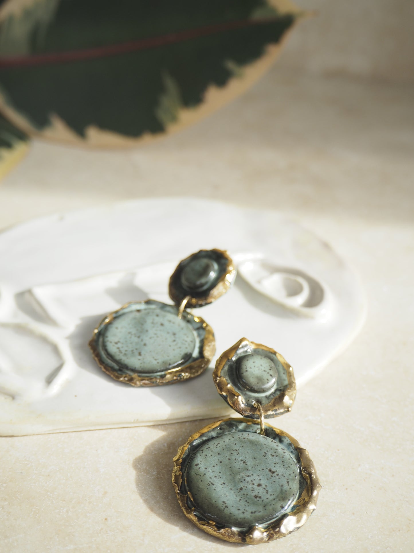Femminilità Porcelain Earrings in a “green speckled ash” coloured glaze with 24k Gold lustre textured rims