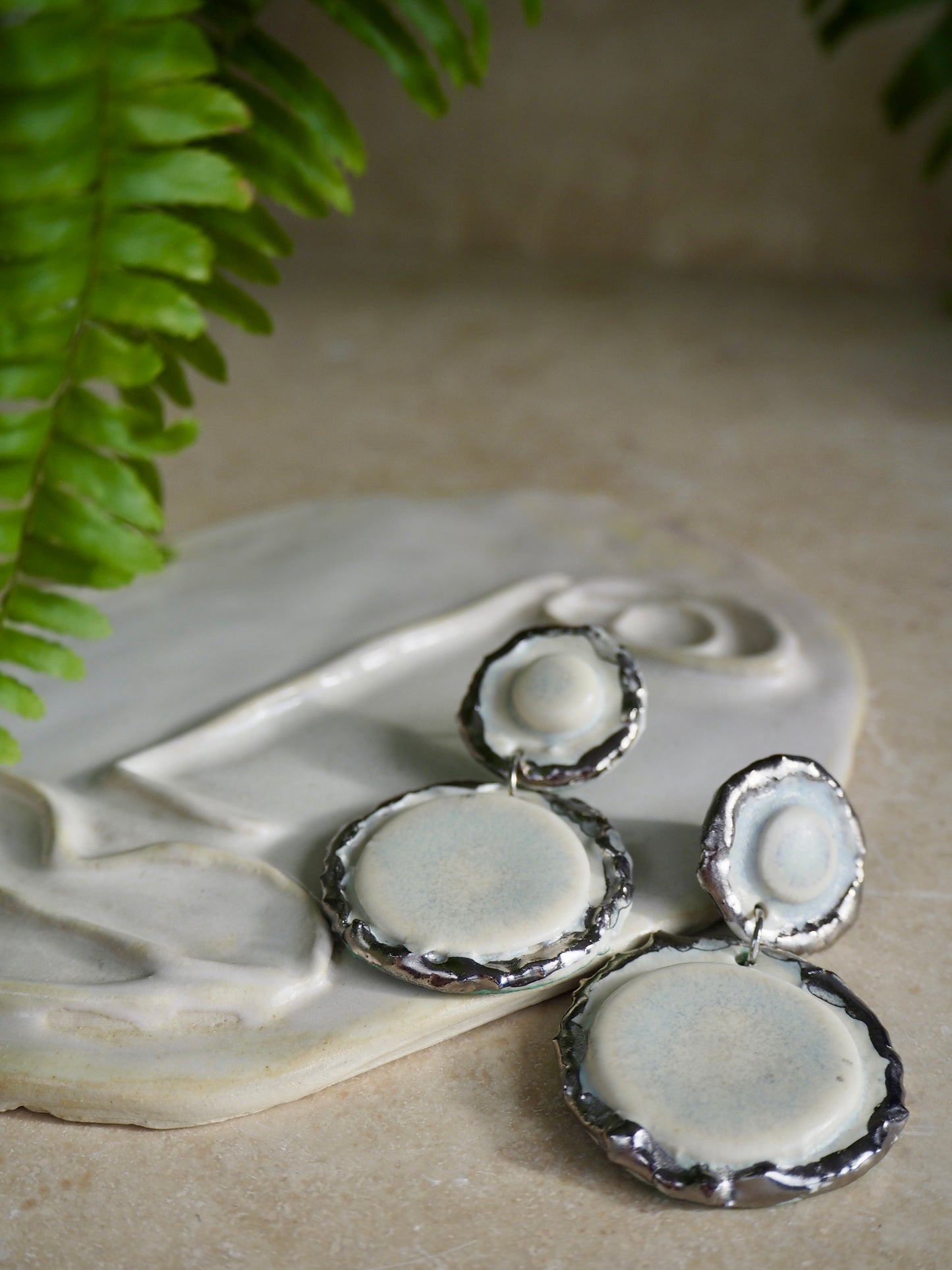Femminilità Porcelain Earrings in “Snow” coloured glaze with Platinum lustre textured rims in a matte finish