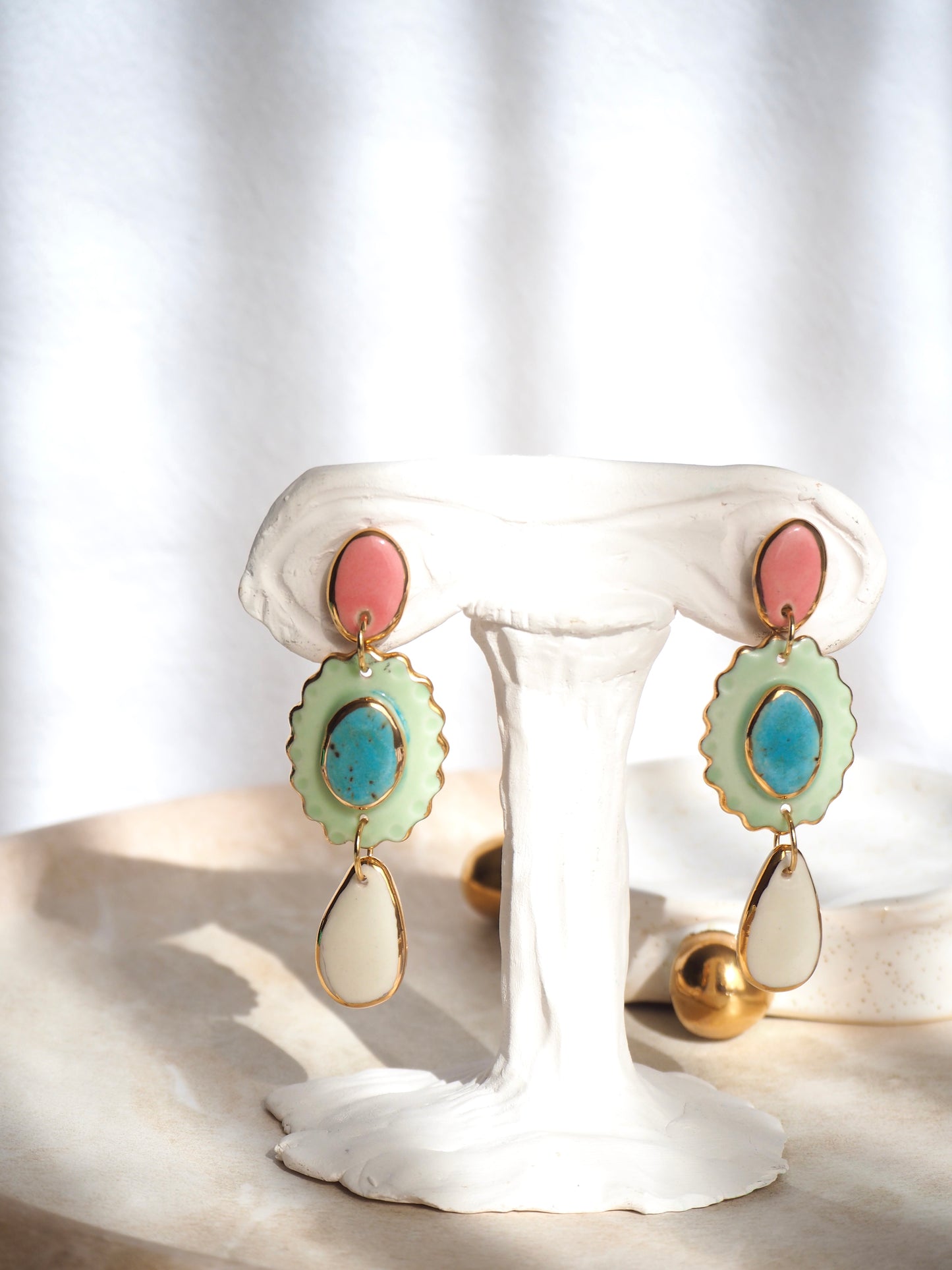 One of a kind Porcelain Earrings coloured with pink , aqua, light green and white glossy glazes with 24k lustre rims