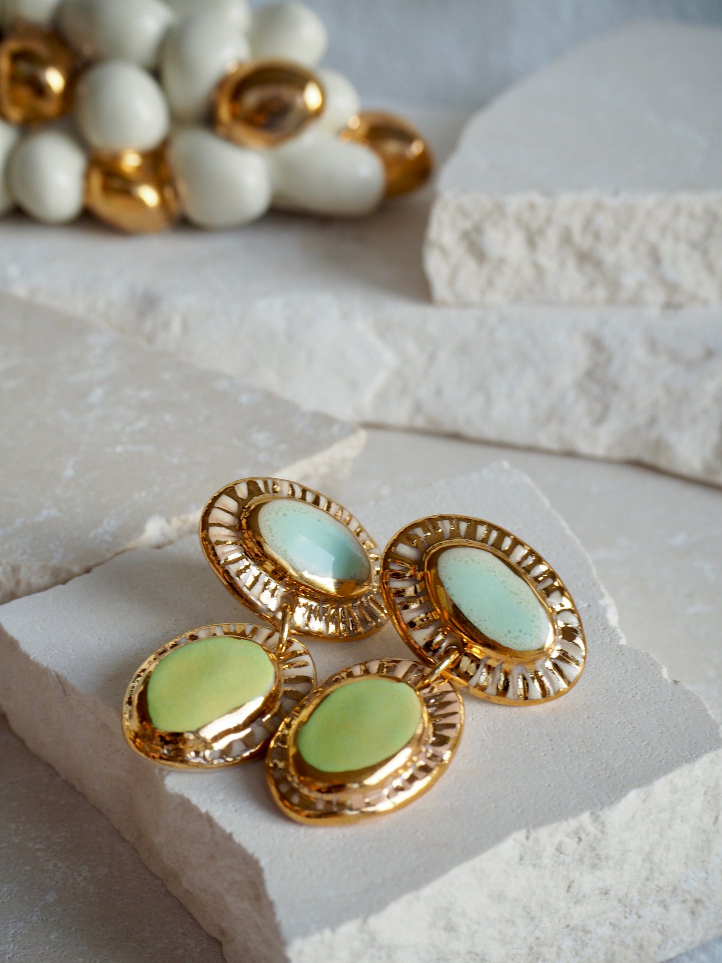 Hideaway Bay “Anima” Handmade Porcelain Earrings with Parchment underglaze and Green & Pale blue glazes with 24k gold lustre rays