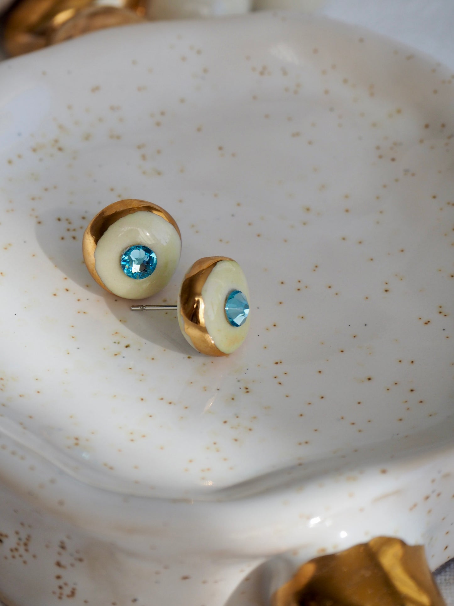 “Supernova” Off White Small Handmade Porcelain Studs with 24k Gold lustre rims and “light blue”Swarovskis Crystal