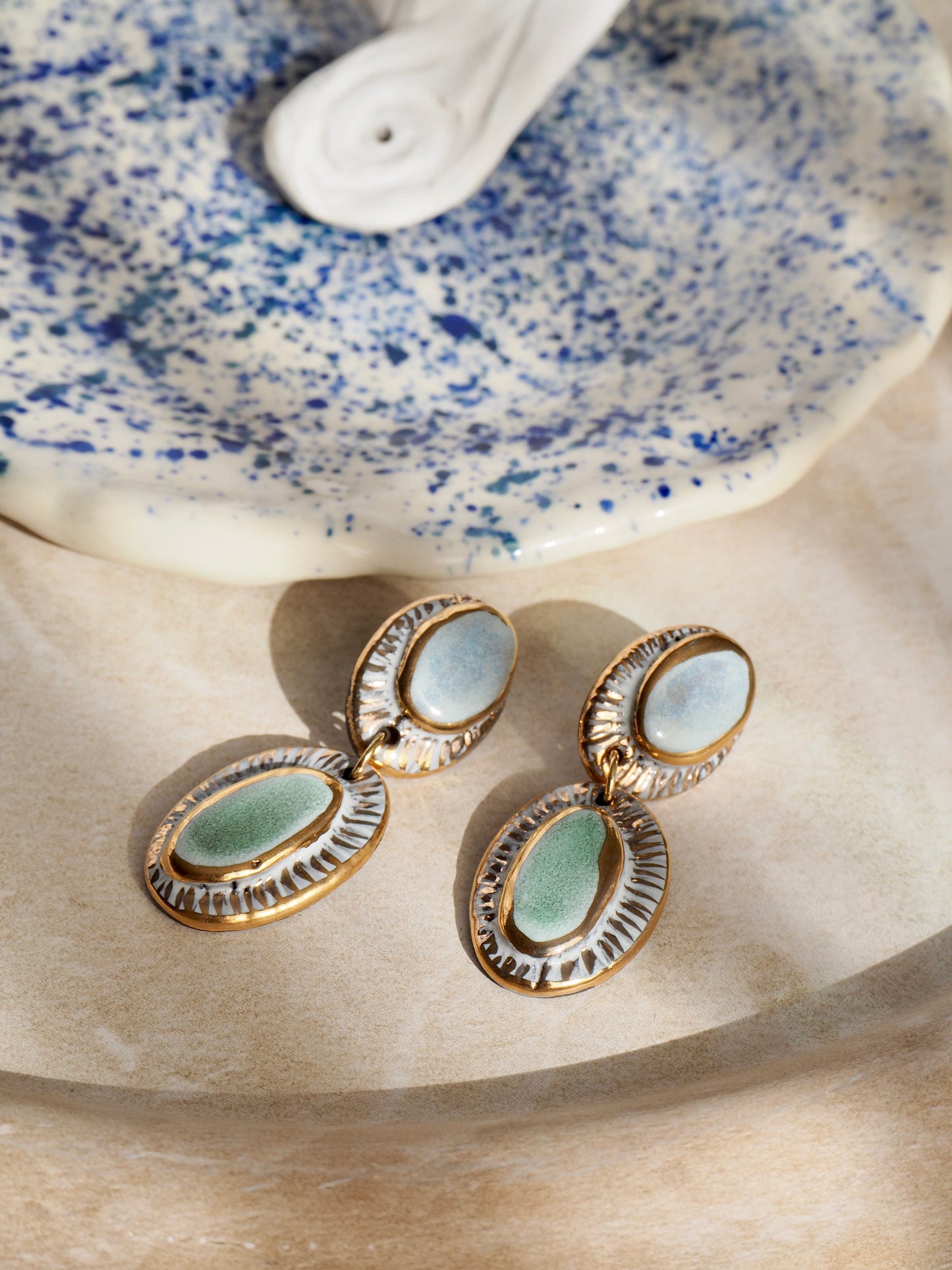 Pietra Collection handmade Black Clay Earrings coloured using light blue and green glaze with 24k gold lustre details